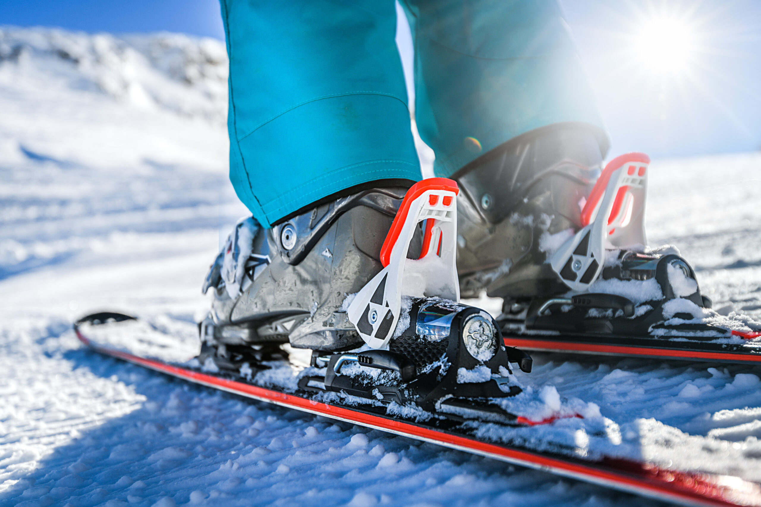 Winter skis and detailed view of the ski bindings concept in sun